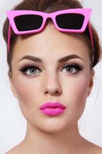 Portrait of young beautiful woman with pink lipstick and stylish